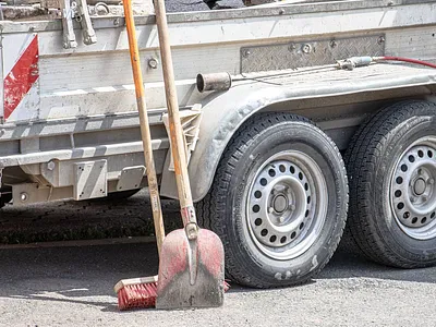 Sealcoating tools and shovels at paving truck