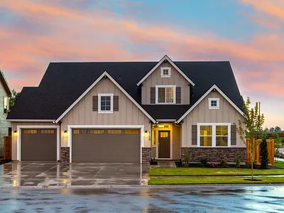 Suburban home with wide concrete driveway at dusk