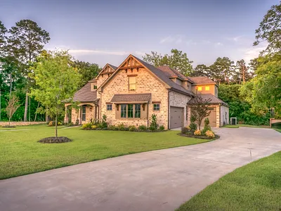Luxury home with curved concrete driveway entrance